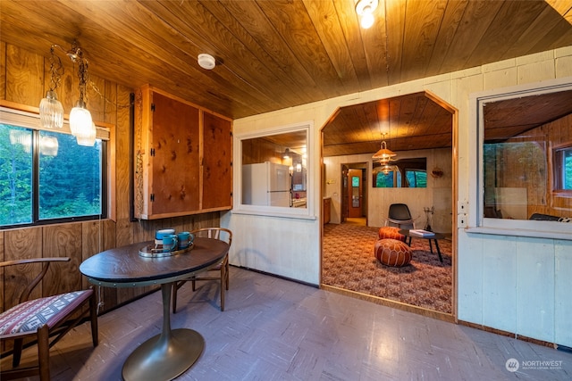 dining room with wood walls