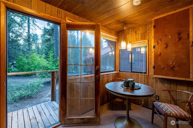 sunroom with plenty of natural light and wooden ceiling