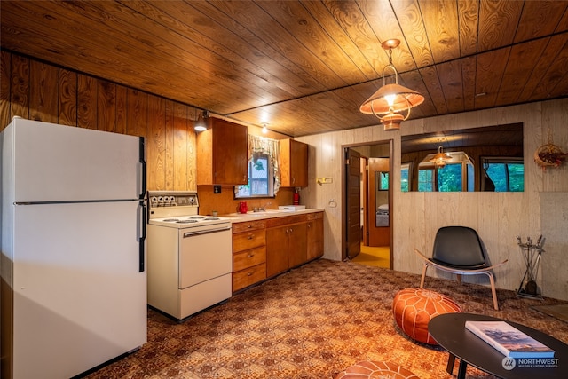 kitchen with wood ceiling, wood walls, pendant lighting, and white appliances