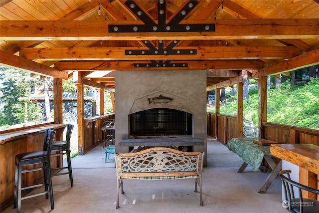 view of patio featuring a gazebo, an outdoor bar, and exterior fireplace