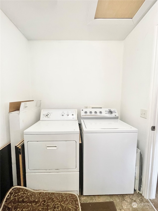 washroom with washing machine and dryer, hookup for a washing machine, and tile flooring