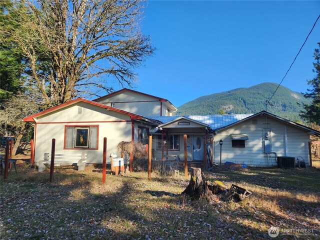 112 Combs Rd, Packwood, WA 98361 - back of property with central air condition unit and a mountain view
