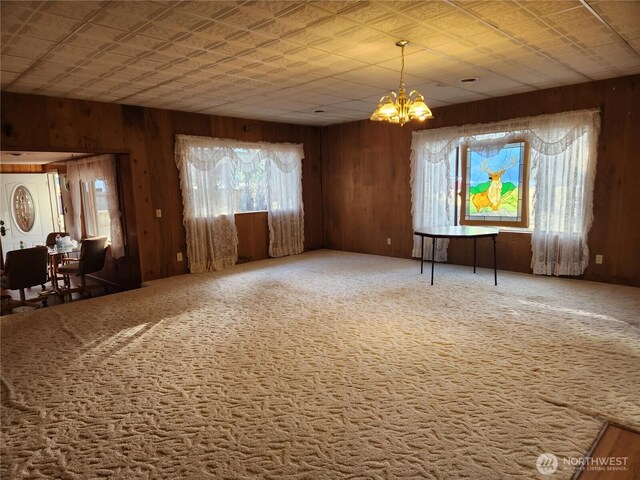 112 Combs Rd, Packwood, WA 98361 - unfurnished living room with wooden walls and an inviting chandelier
