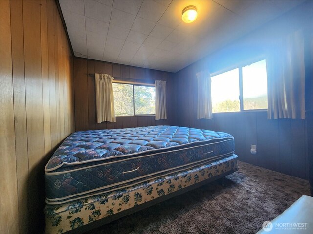 112 Combs Rd, Packwood, WA 98361 - carpeted bedroom with wood walls