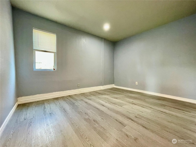 empty room with light hardwood / wood-style flooring