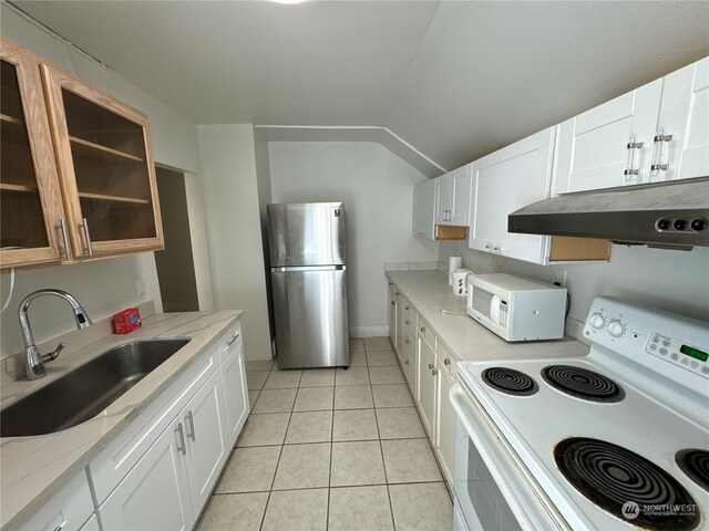 kitchen featuring white appliances, light tile patterned flooring, light stone countertops, white cabinets, and sink