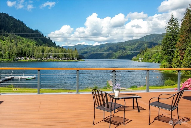 deck with a water and mountain view