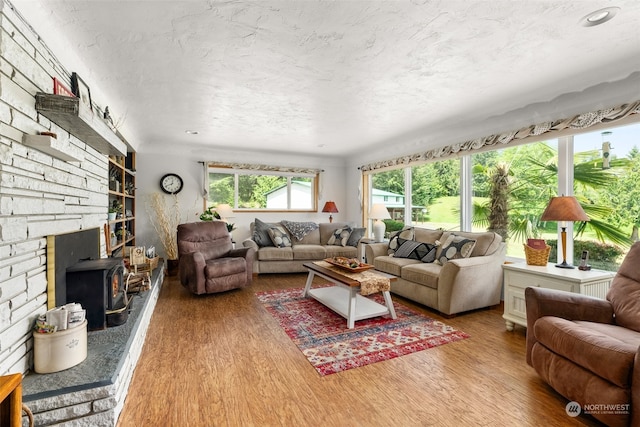 living room featuring wood-type flooring and a wood stove