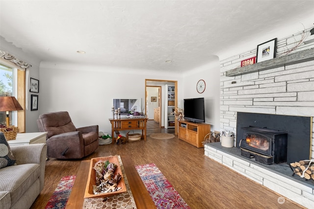 living room featuring a wood stove and dark hardwood / wood-style floors