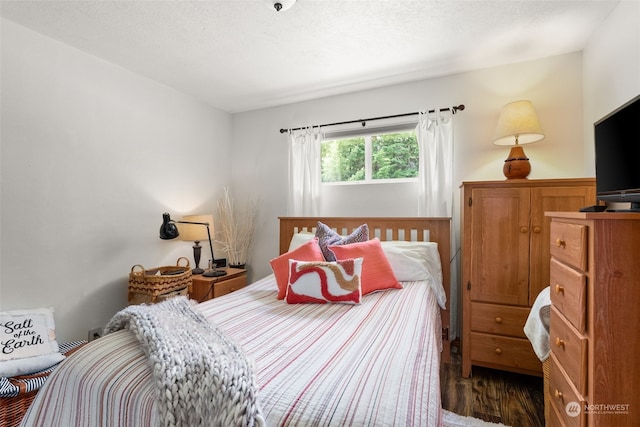 bedroom featuring dark hardwood / wood-style flooring