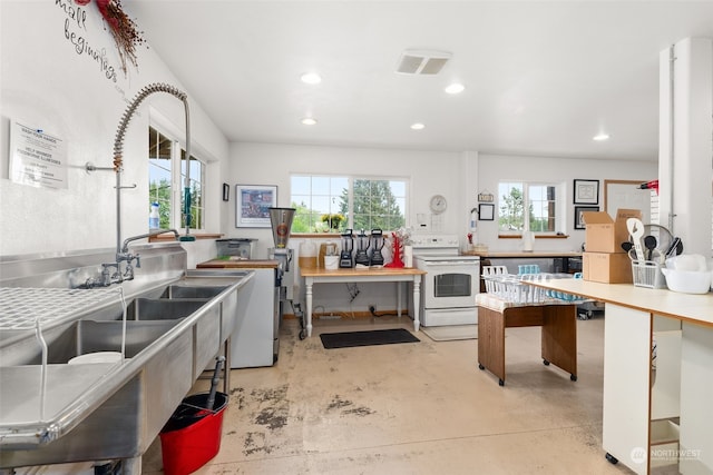 kitchen featuring a healthy amount of sunlight and white electric range oven