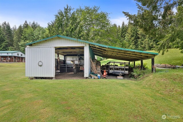 view of outbuilding featuring a yard