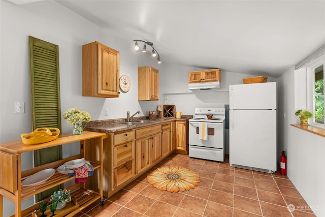 kitchen featuring white appliances, vaulted ceiling, sink, light brown cabinets, and tile patterned flooring