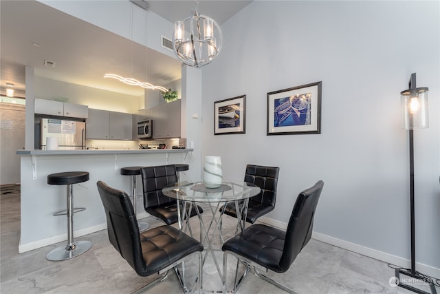 dining room featuring a notable chandelier and light tile floors