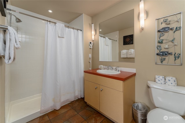 bathroom featuring tile flooring, large vanity, and toilet