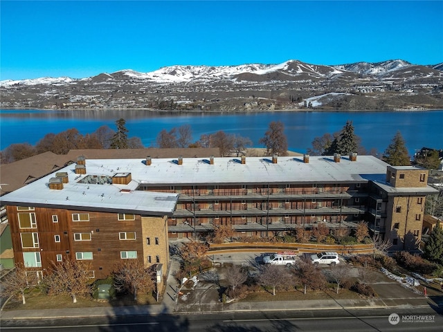 aerial view of a water and mountain view and apartment complex