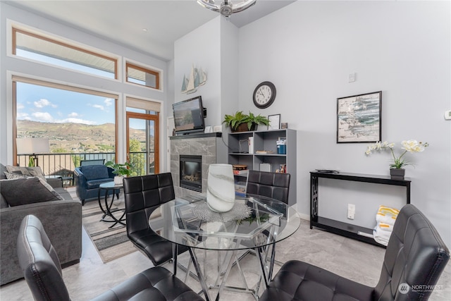 living room with a high ceiling and a tile fireplace