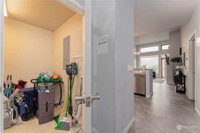 hallway featuring electric panel and baseboards