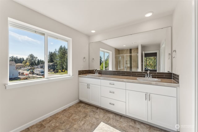 bathroom featuring vanity and a shower with door