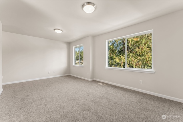 unfurnished room featuring carpet