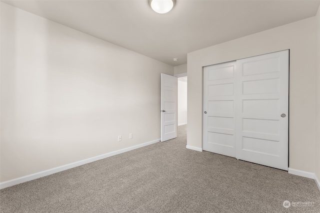 unfurnished bedroom featuring a closet and carpet floors