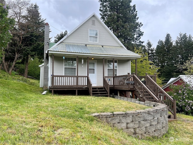 back of property featuring a porch and a lawn