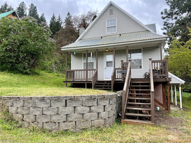 rear view of property with a yard