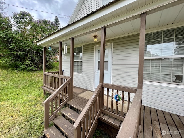 wooden deck featuring a yard