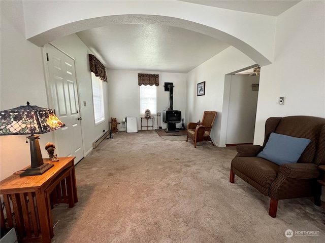 sitting room featuring a baseboard radiator, a textured ceiling, and carpet floors