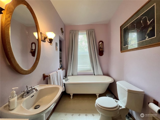 bathroom featuring tile floors, sink, a bathing tub, and toilet