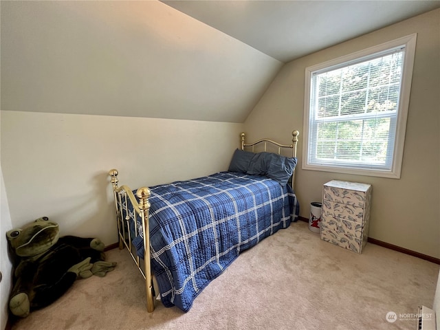 bedroom featuring lofted ceiling and carpet