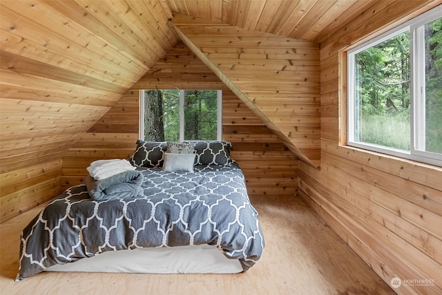 bedroom featuring hardwood / wood-style floors, wood ceiling, and lofted ceiling