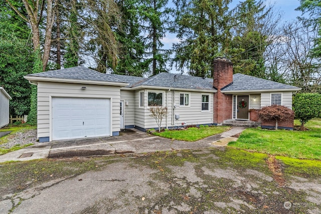 single story home with a front yard and a garage