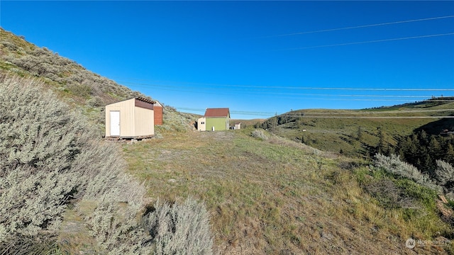 view of yard with a storage unit and an outbuilding