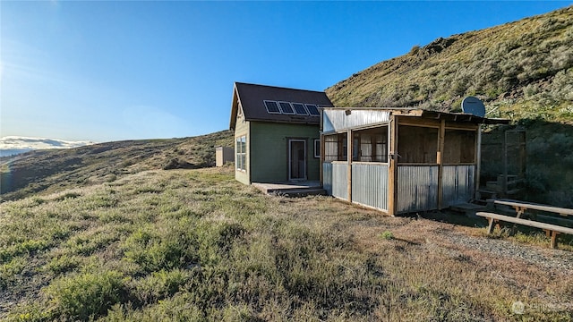 back of house featuring an outbuilding and a mountain view