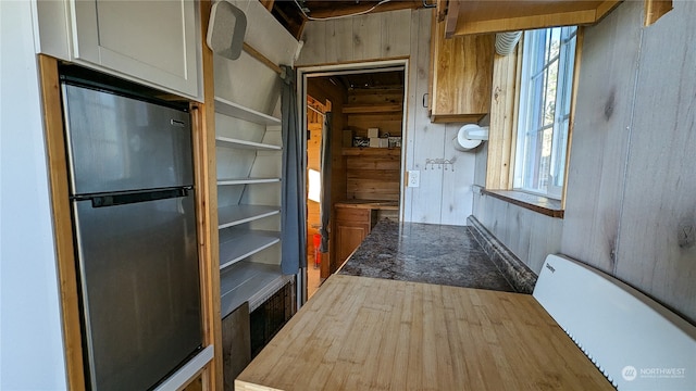 hall featuring wooden walls and wood finished floors