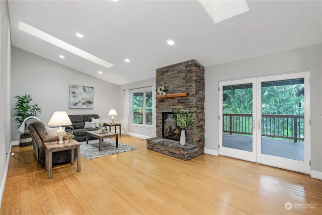 living room featuring a wealth of natural light, light hardwood / wood-style floors, and a fireplace