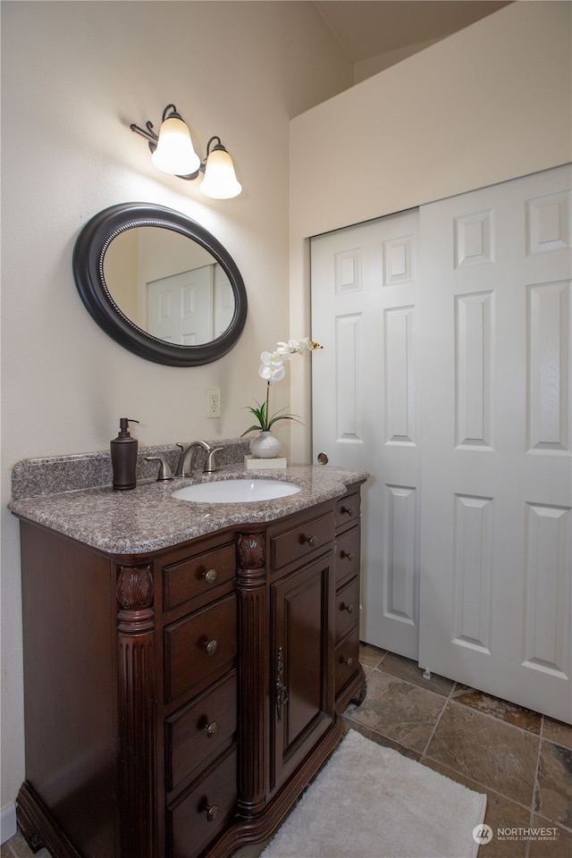 bathroom featuring tile flooring and vanity