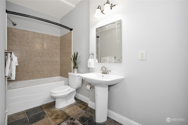 full bathroom with tile floors, sink, toilet, and tiled shower / bath