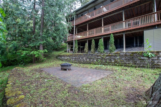 view of yard with a patio, an outdoor fire pit, and a wooden deck