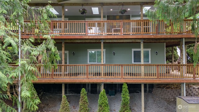 rear view of property featuring a deck