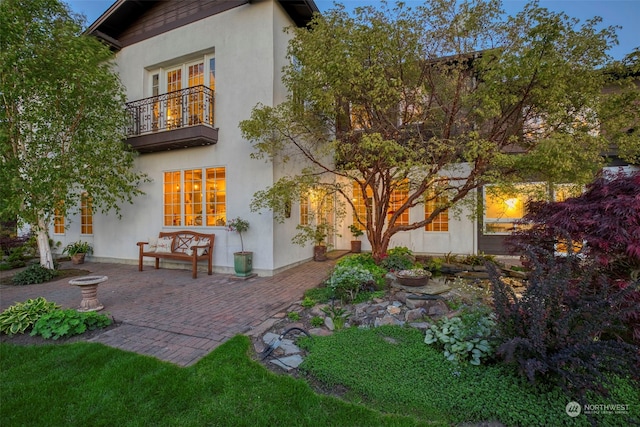 back of property with a patio and a balcony