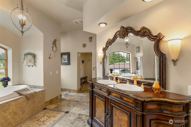 bathroom with tile flooring, lofted ceiling, an inviting chandelier, dual bowl vanity, and a bathtub