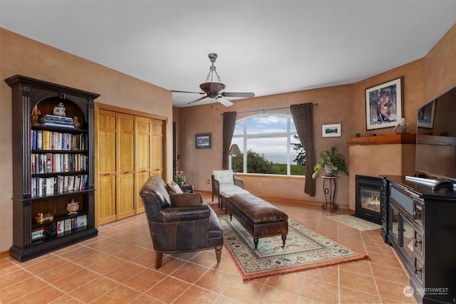 living room with ceiling fan and light tile floors