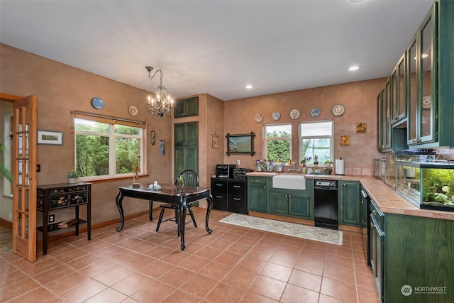 kitchen featuring a healthy amount of sunlight, black dishwasher, and green cabinets