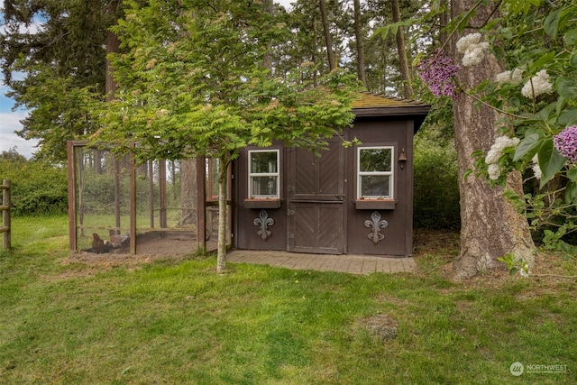 view of outdoor structure featuring a lawn