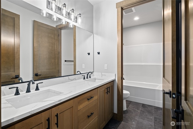 full bathroom with toilet, double vanity, a sink, and visible vents