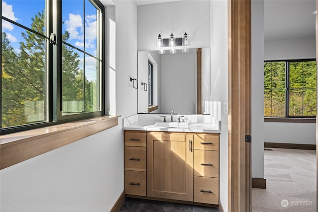 bathroom with vanity and baseboards