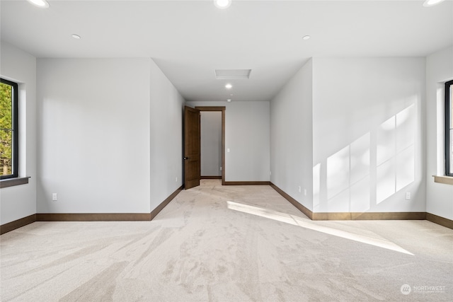 carpeted empty room with attic access, recessed lighting, and baseboards