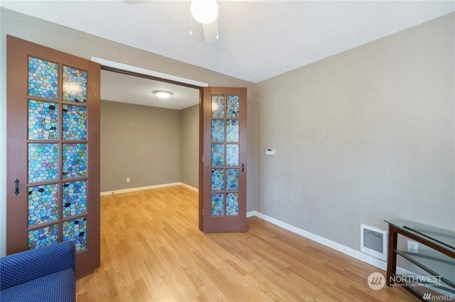 unfurnished room with ceiling fan and light hardwood / wood-style flooring